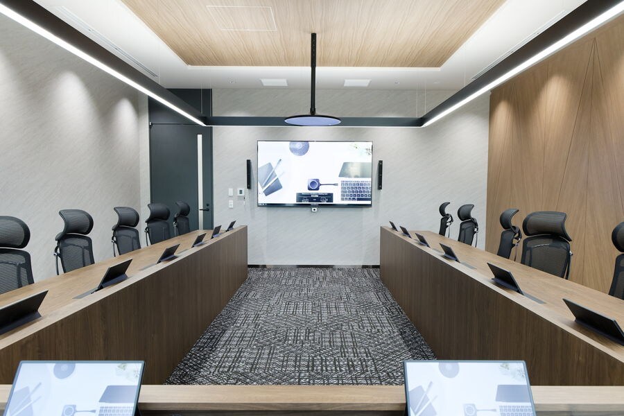 Executive meeting room with a large display and conference table